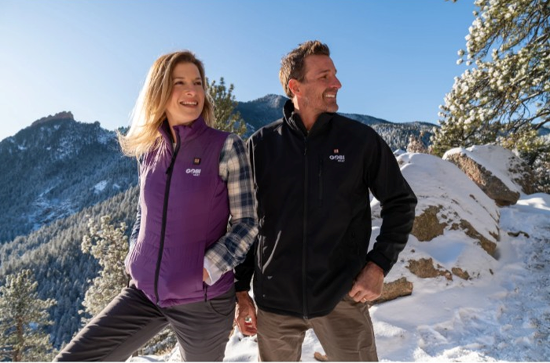 Photo of couple in the mountains wearing the best-heated-jacket