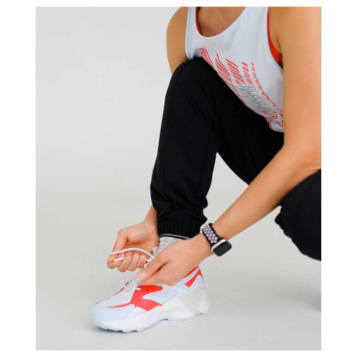 Woman lacing up her running shoes