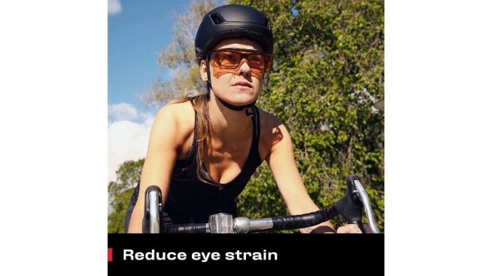 Photo of woman cycling using blue-light-blocking safety glasses