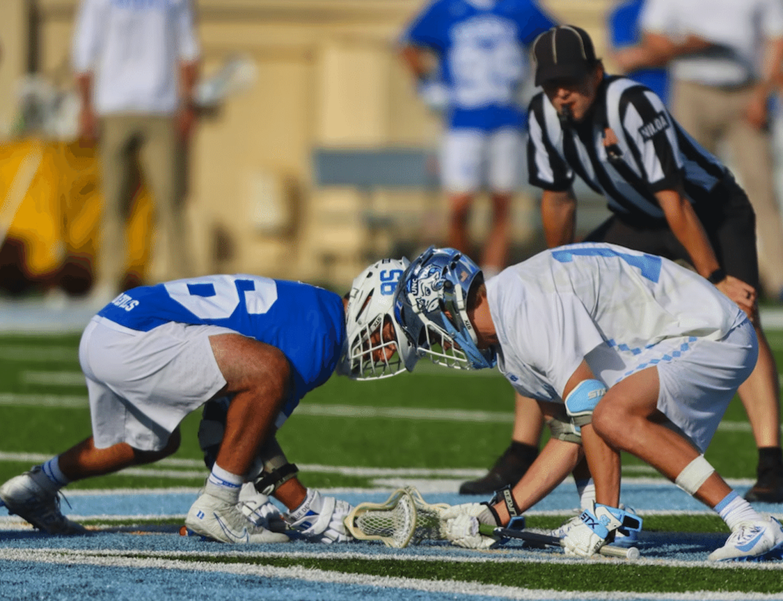 Photo of face off during a Lacrosse Game.