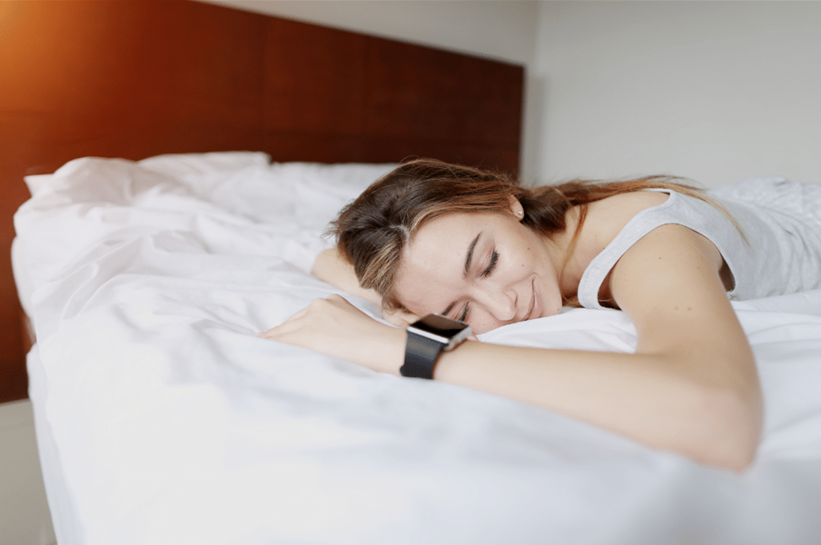 Photo of women sleeping with a sleep tracker